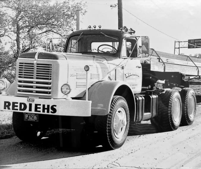 Black-and-white photo of Rediehs flatbed with cargo