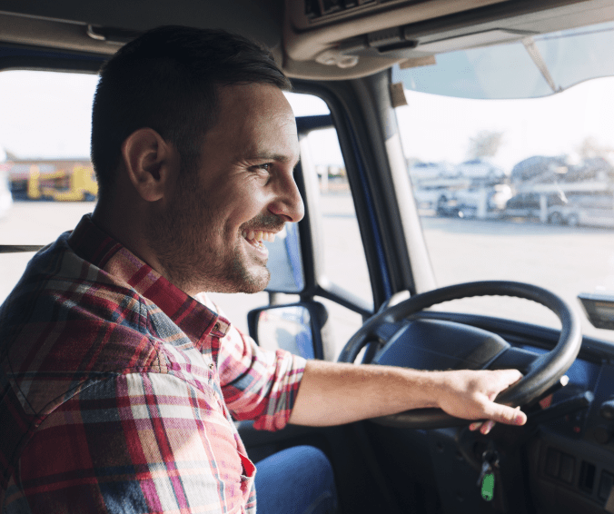 Close-up of smiling man driving truck