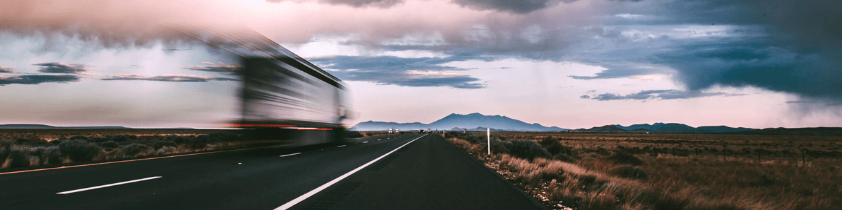 Highway with a blurred truck, indicating movement