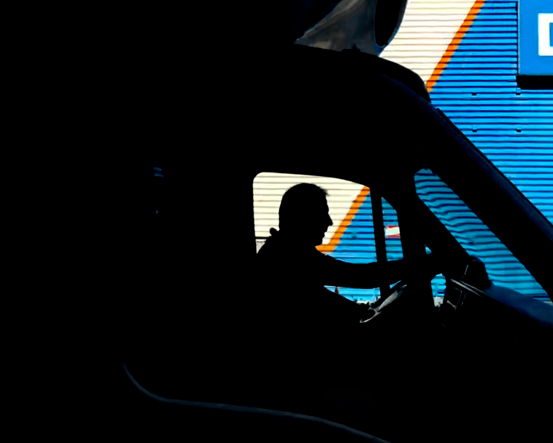 Silhouette of driver in cab of truck